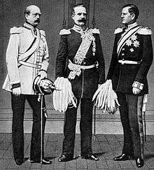three men in military uniforms carrying pickel helmets—the ones with pikes sticking out of the crowns